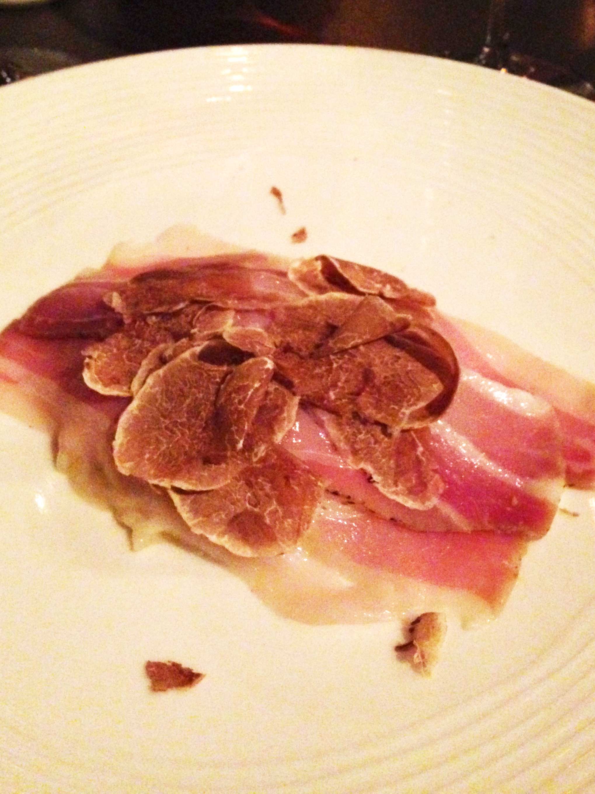 White truffles and pancetta atop risotto